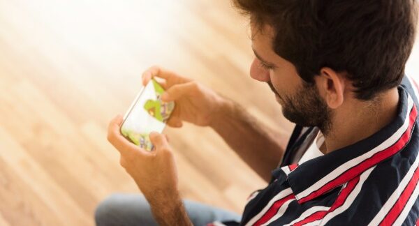 melhores jogos mobile - Homem jogando com um celular